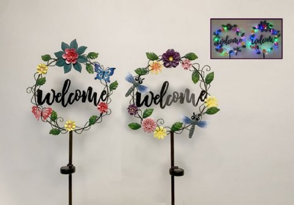 Two decorative 'welcome' signs with floral designs and solar powered LEDs on a white background.