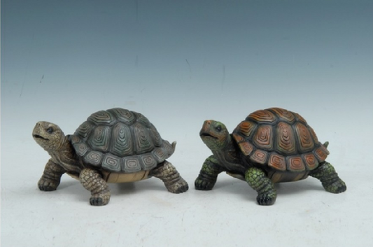 Two turtle figurines on a plain background