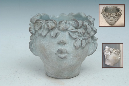 Decorative vase shaped like a face from the nose down with floral hair on a light gray background