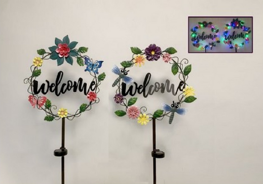 Two decorative 'welcome' signs with floral designs and solar powered LEDs on a white background.